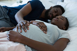 pregnant couple sleeping